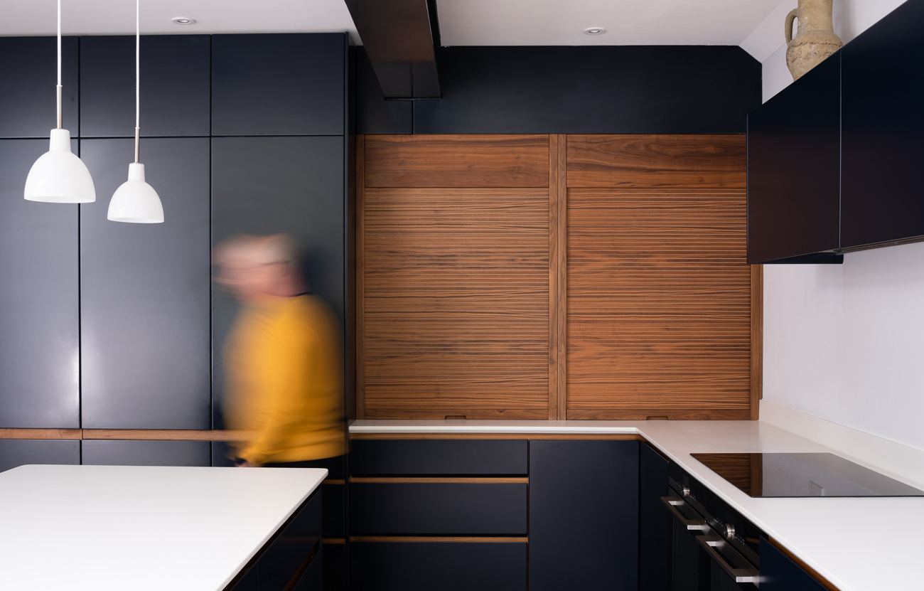 Cantilever House tambour unit in walnut with blurred person